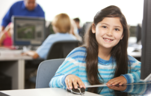 girl-sat-at-computer-smiling